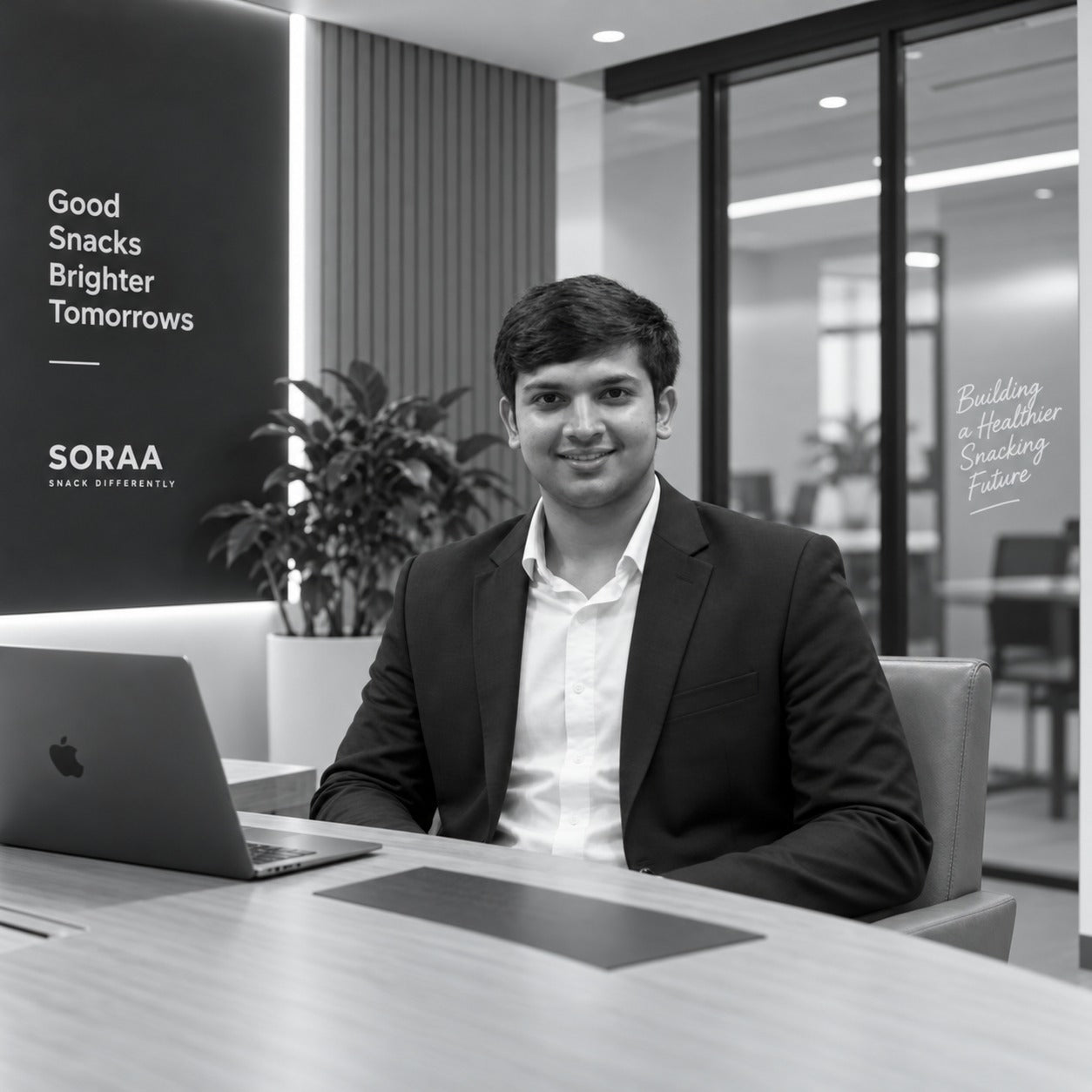 SORAA founder seated at an office desk