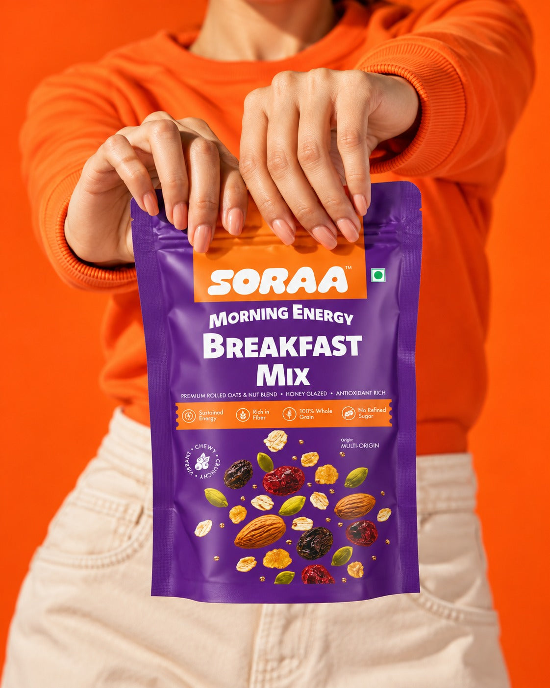 SORAA Morning Energy Breakfast Mix held against a bright orange background